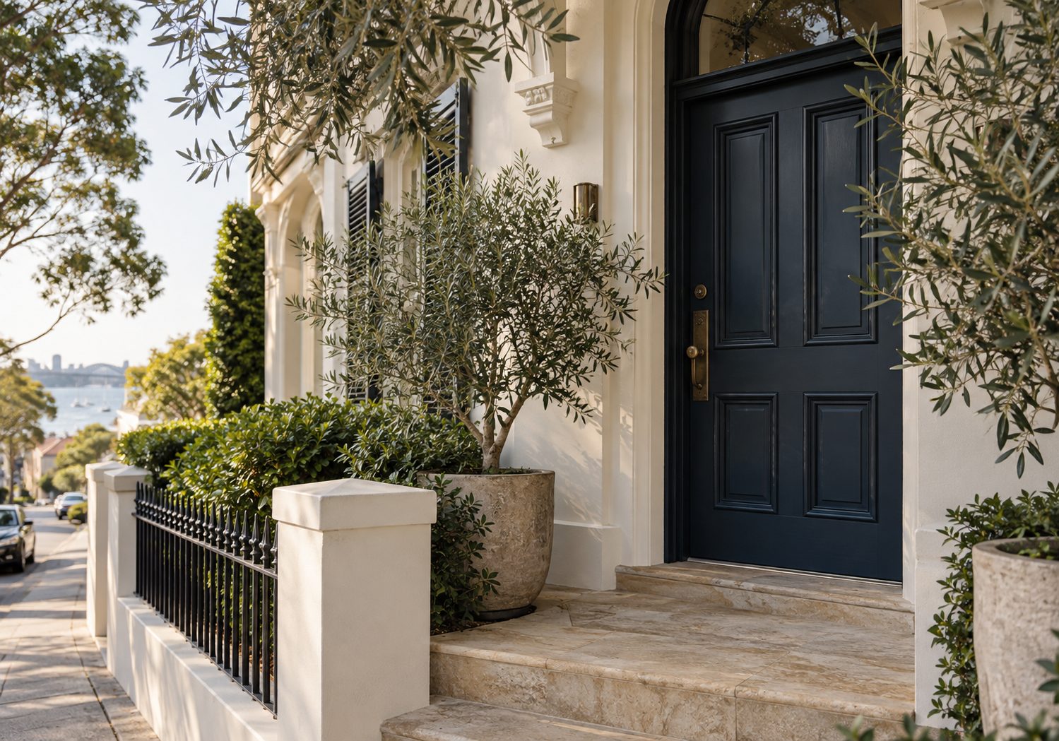 Illustration of a terrace house entrance, with a dark timber door, a sandstone step and potted olive trees.